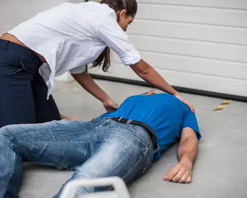 person crouched above someone unconcious